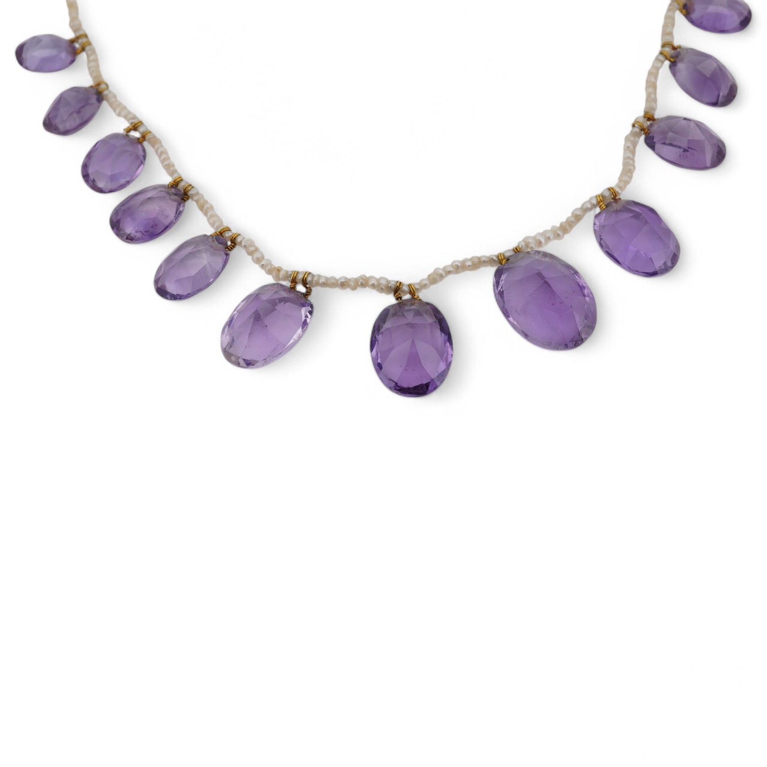 An early 20th century seed pearl and graduated oval cut amethyst set fringe necklace, 36cm. Condition - fair to good